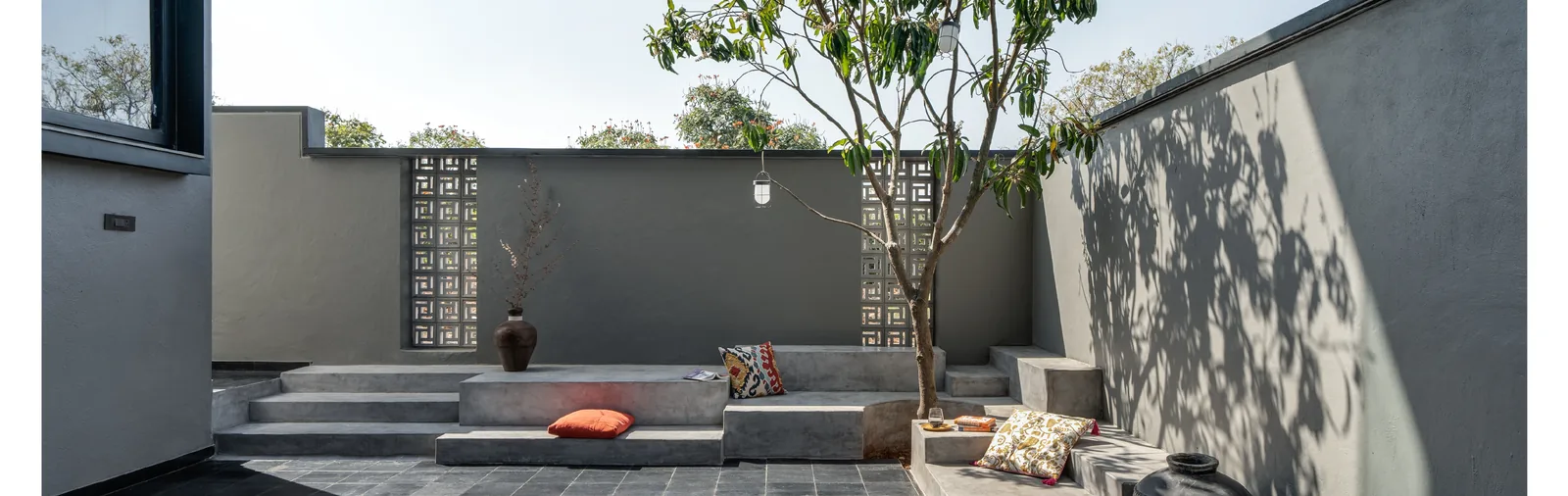 Open courtyard with a central tree and seating